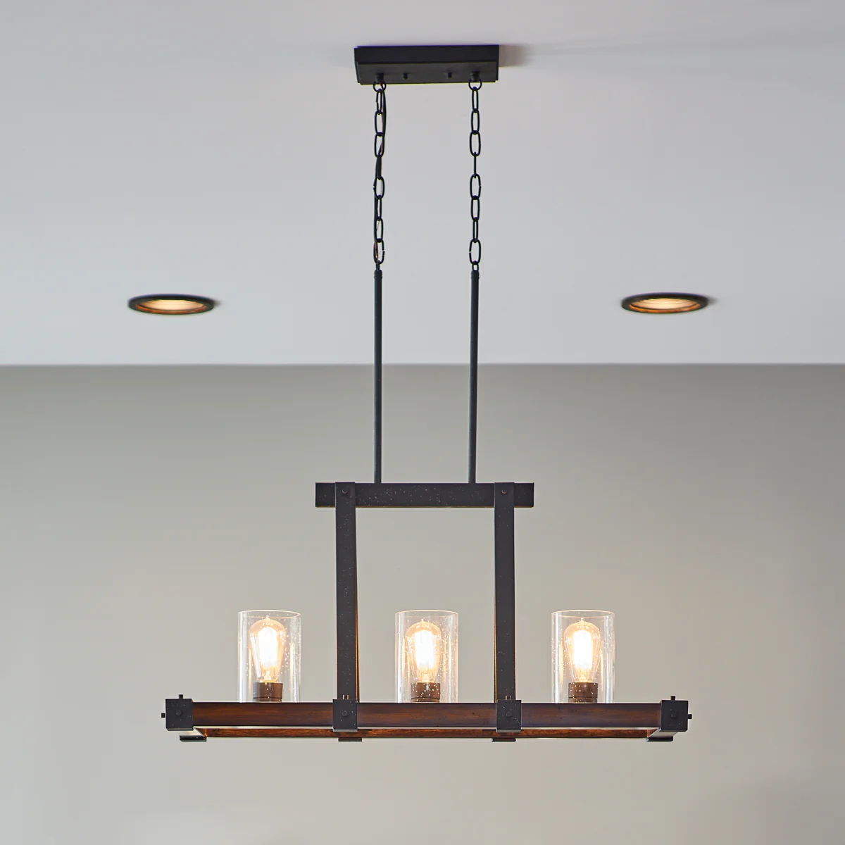 Kichler Barrington Distressed Black & Wood Tone Linear Kitchen Island Light with Clear Seeded Glass, 32 in. - Image 9
